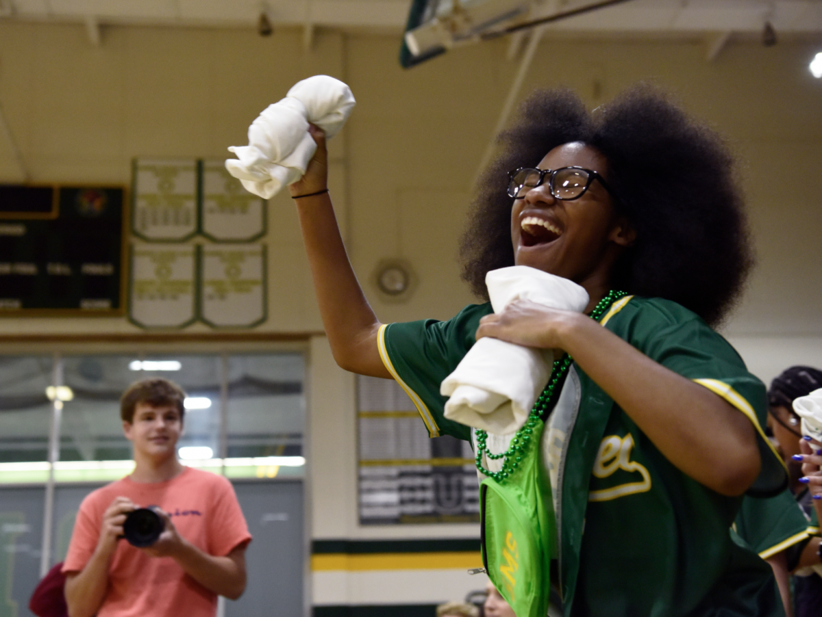 Jogging out with a little pep in her step, senior Gabby Jarrett makes her way across the gym and begins tossing pep club t-shirts to the crowd as she is introduced over the mic as one of the 24-25 club members during an assembly